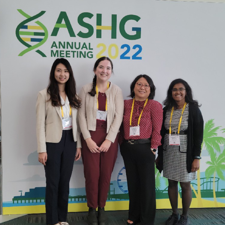 Sara, Sarah, Amirtha, and Qing standing in front of a sign that says 'ASHG Annual Meeting 2022'